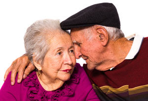 Elderly man comforting partner.