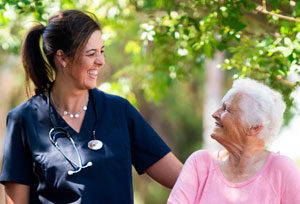 Nurse smiling at elderly woman.